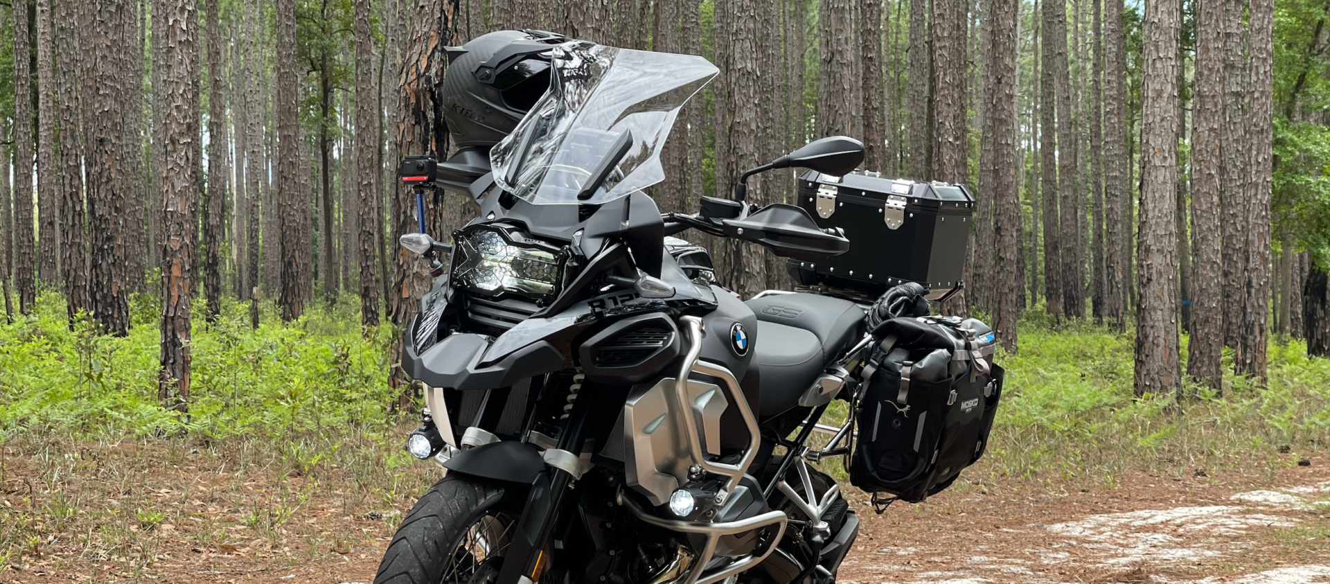 2021 BMW R1250GS Adventure Triple Black with a forest background